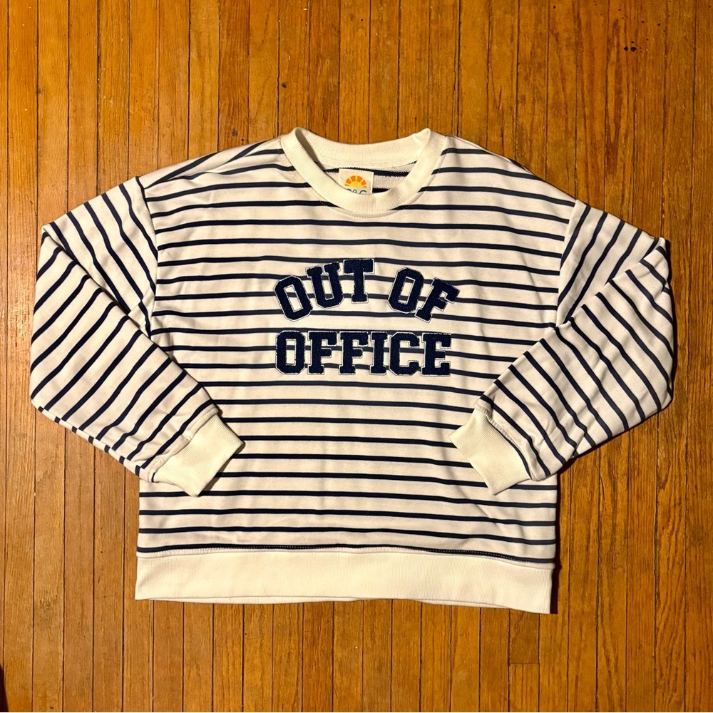 Blue chenille OUT OF OFFICE centered on this blue and white striped sweatshirt